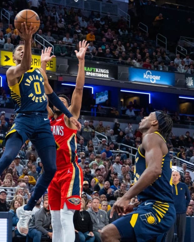 Nov 7, 2022; Indianapolis, Indiana, USA; Indiana Pacers guard Tyrese Haliburton (0) dribbles the ball whileNew Orleans Pelicans guard CJ McCollum (3) defends in the second half at Gainbridge Fieldhouse. Mandatory Credit: Trevor Ruszkowski-USA TODAY Sports